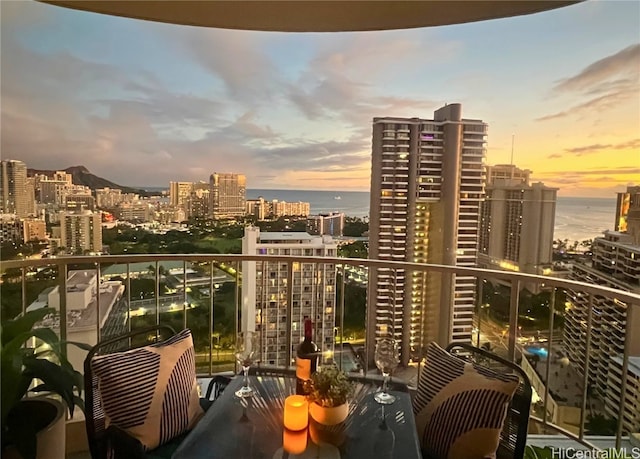 balcony at dusk with a view of city