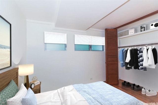 bedroom featuring hardwood / wood-style floors and a closet