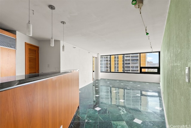 interior space with pendant lighting and stainless steel counters