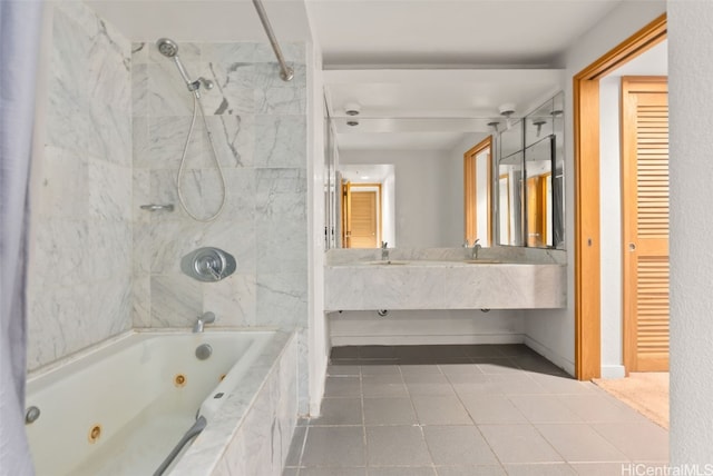 bathroom featuring tile patterned flooring, vanity, and tiled shower / bath combo