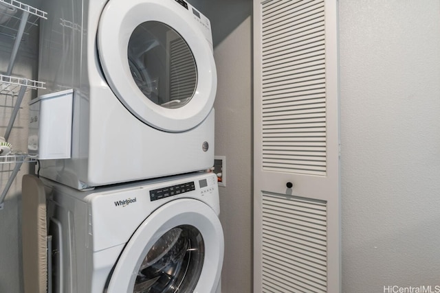 laundry area featuring stacked washer / dryer