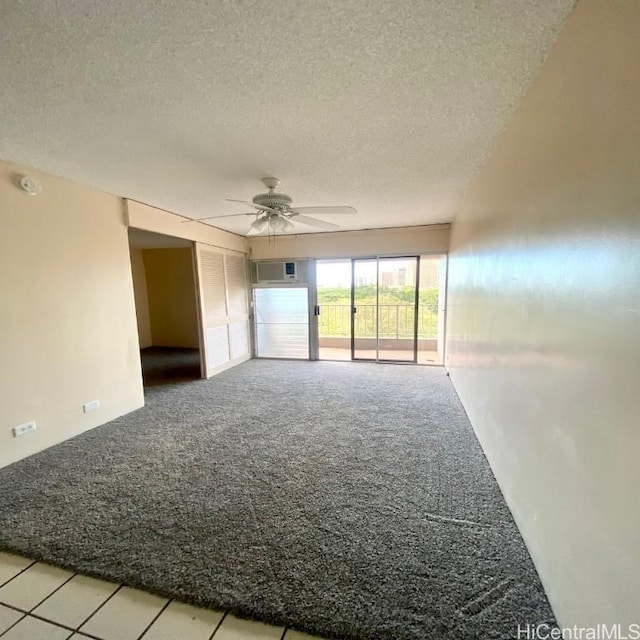 carpeted spare room with a textured ceiling and ceiling fan