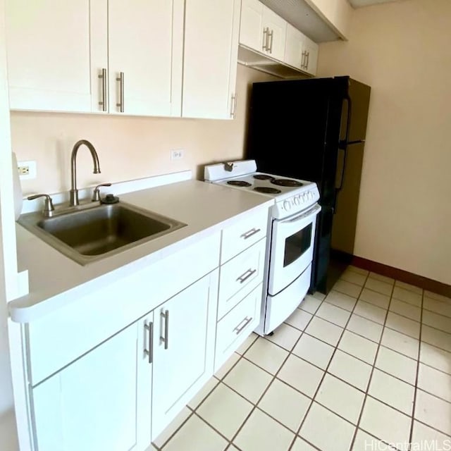 kitchen with sink, white cabinetry, white stove, and light tile patterned floors