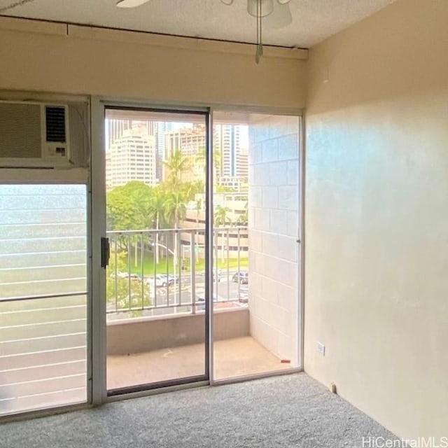 doorway to outside with carpet and an AC wall unit