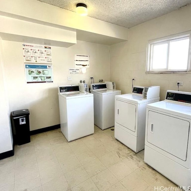 laundry area with washer and dryer and a textured ceiling