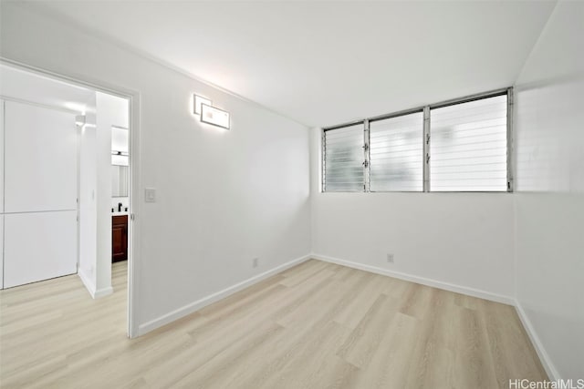 spare room featuring light hardwood / wood-style floors