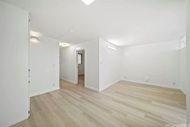 spare room with light hardwood / wood-style flooring