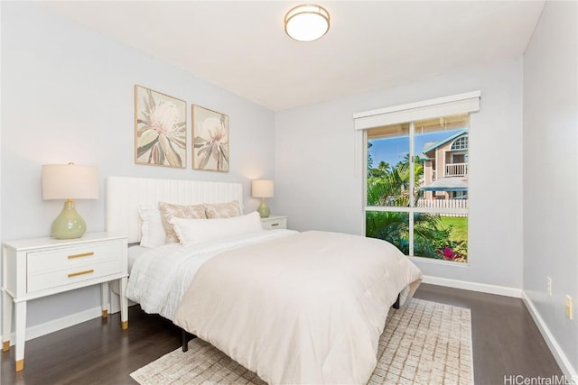 bedroom with dark hardwood / wood-style floors