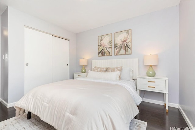 bedroom featuring dark hardwood / wood-style flooring and a closet