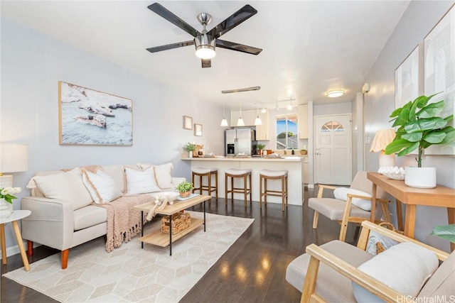 living room featuring hardwood / wood-style flooring and ceiling fan