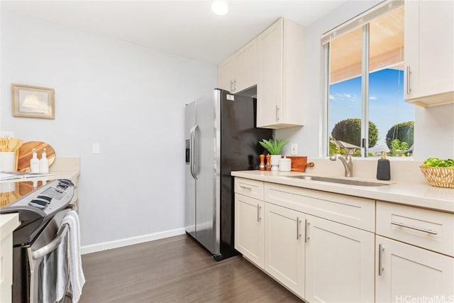 kitchen with white cabinets, stainless steel fridge, dark hardwood / wood-style floors, and sink