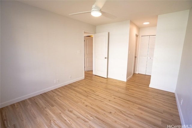 unfurnished bedroom with light wood-type flooring, a closet, and ceiling fan