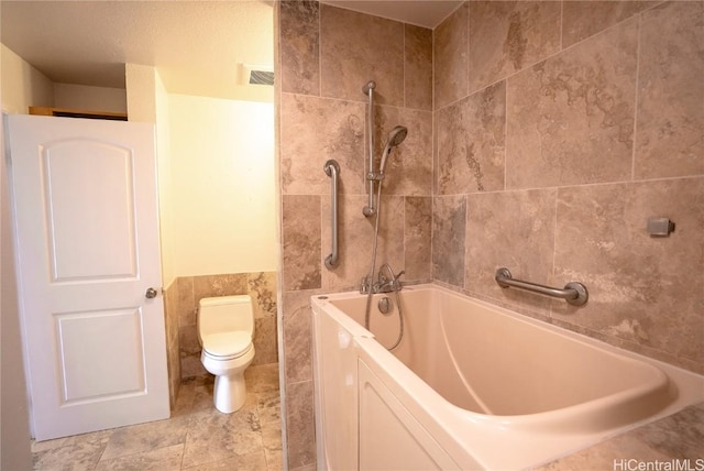 bathroom with tiled shower / bath combo and toilet