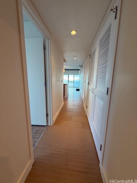 hallway with light hardwood / wood-style floors