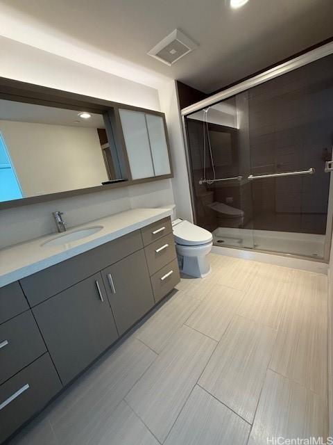 bathroom with vanity, toilet, and walk in shower