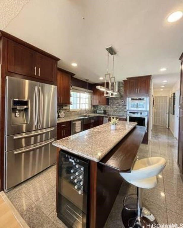 kitchen with stainless steel refrigerator with ice dispenser, backsplash, beverage cooler, decorative light fixtures, and a kitchen island