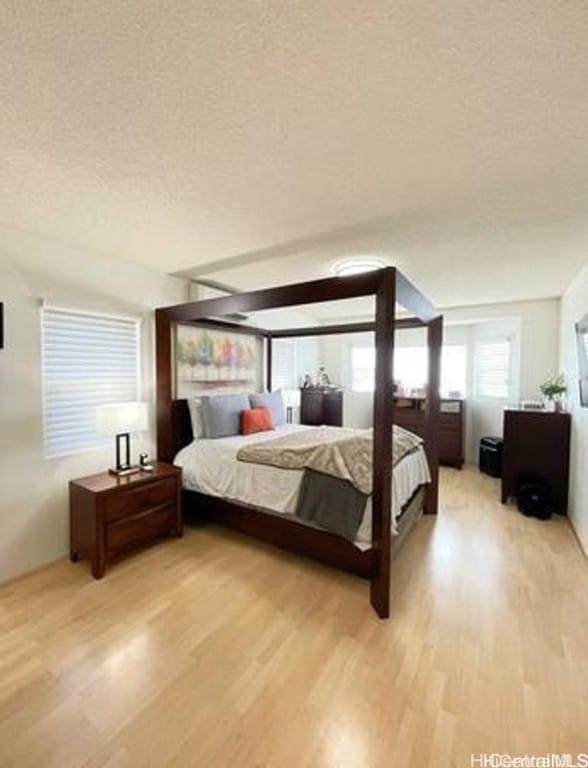 bedroom featuring a textured ceiling and light wood-type flooring