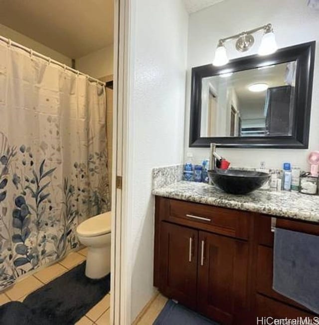 bathroom with tile patterned floors, vanity, and toilet