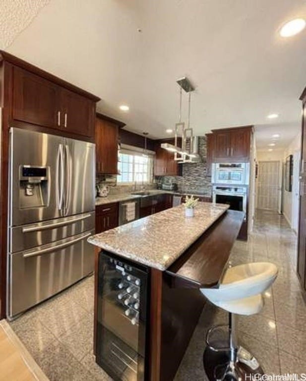 kitchen with tasteful backsplash, a kitchen island, stainless steel fridge with ice dispenser, wine cooler, and hanging light fixtures