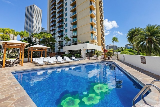 view of swimming pool with a gazebo and a patio area