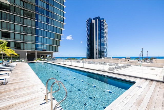 view of pool with a water view