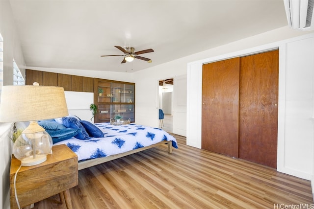 bedroom featuring hardwood / wood-style flooring, ceiling fan, and a closet