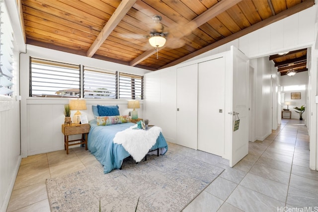 tiled bedroom featuring vaulted ceiling with beams, ceiling fan, and wood ceiling