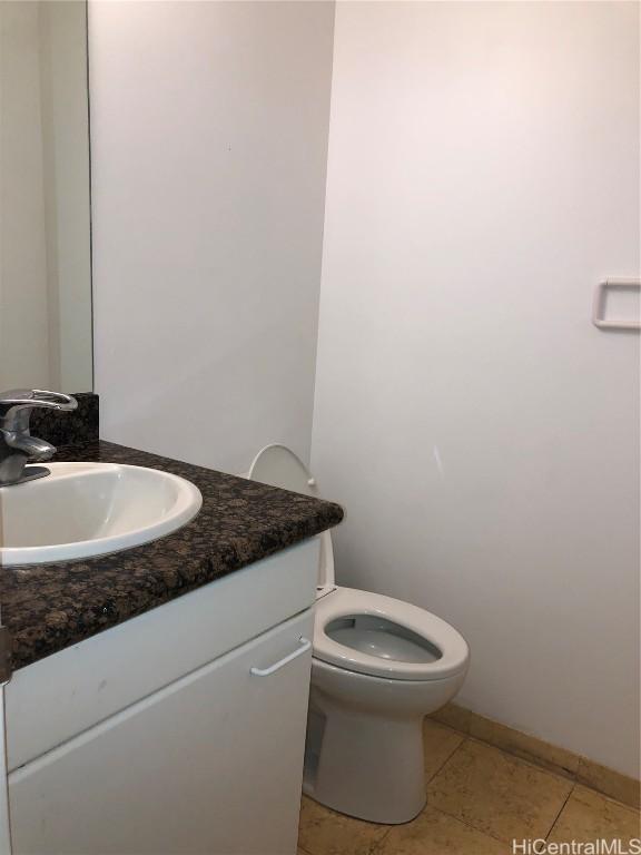 bathroom featuring tile patterned flooring, vanity, and toilet