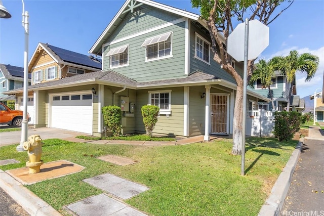 view of front of home with a front yard and a garage