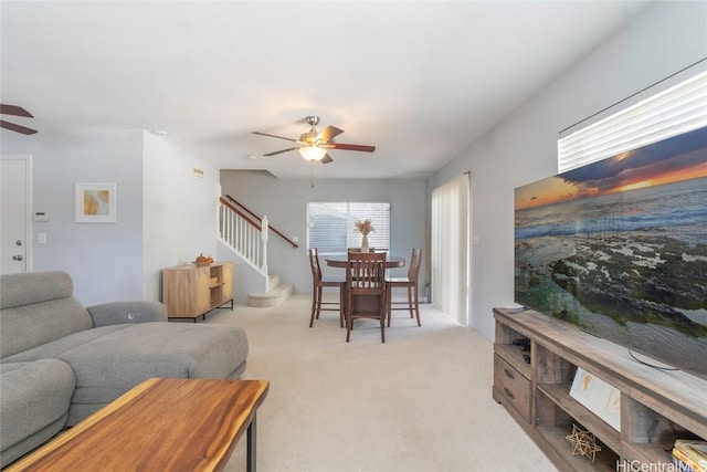 living room with ceiling fan and light colored carpet