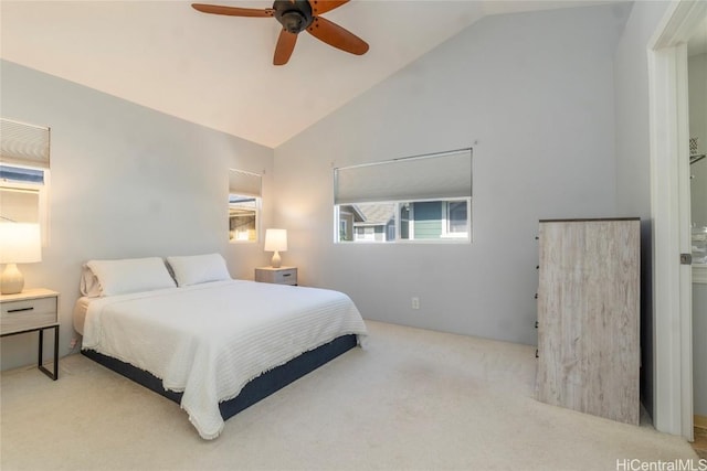 bedroom featuring ceiling fan, light colored carpet, and lofted ceiling