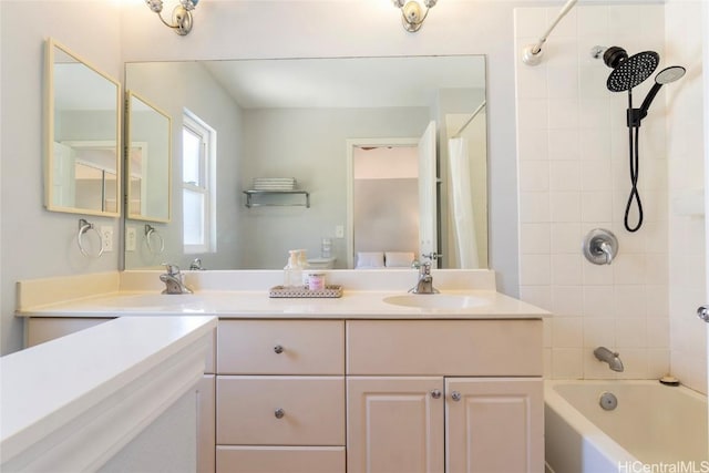 bathroom with vanity and tiled shower / bath combo