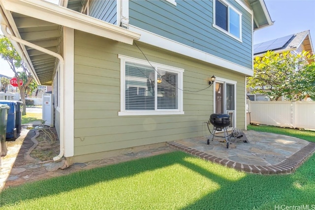 back of house with a lawn and a patio