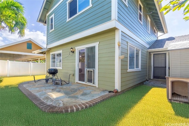 back of property with a patio and a lawn