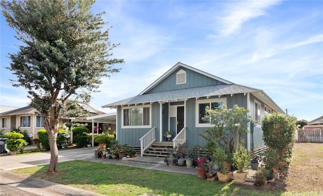 view of front facade featuring a front lawn and a carport