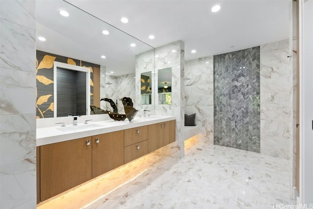 bathroom featuring vanity and tile walls