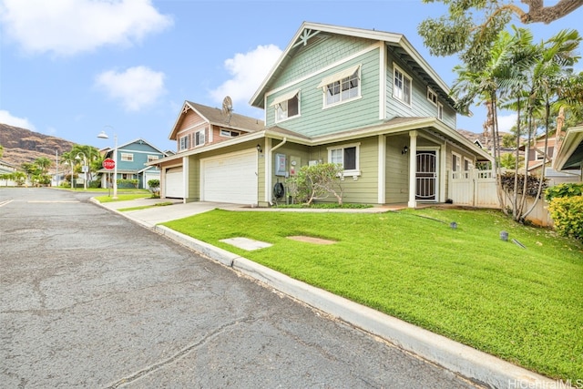 view of front of property with a front yard and a garage