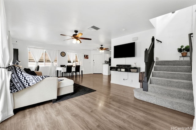 living room with ceiling fan and hardwood / wood-style flooring