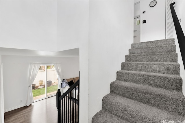 staircase with hardwood / wood-style flooring