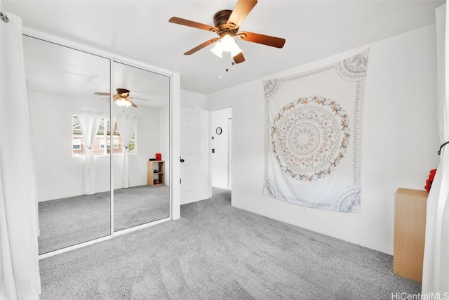 unfurnished bedroom featuring ceiling fan, carpet floors, and a closet