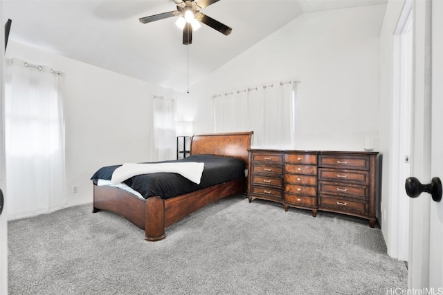 carpeted bedroom featuring vaulted ceiling and ceiling fan