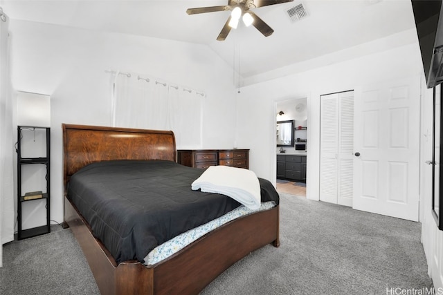 carpeted bedroom featuring connected bathroom, a closet, ceiling fan, and lofted ceiling