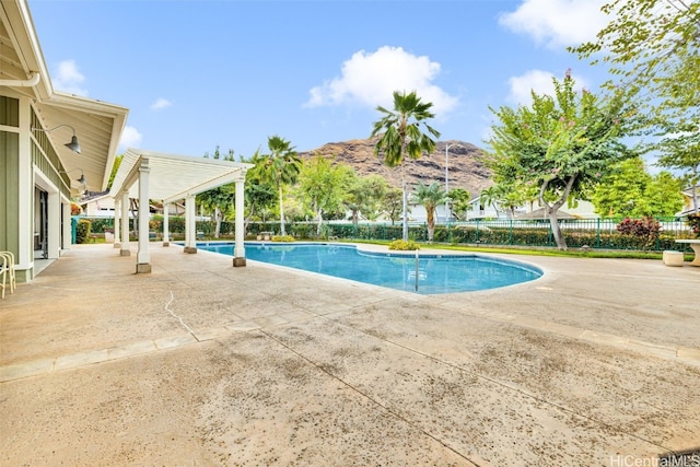 view of pool with a mountain view, a pergola, and a patio