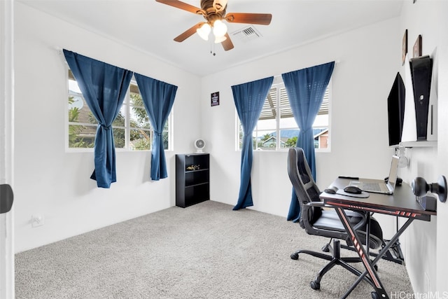 home office with ceiling fan, plenty of natural light, and carpet