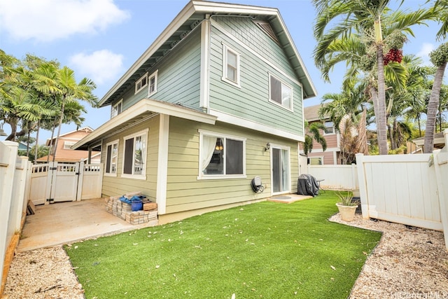 back of house featuring a yard