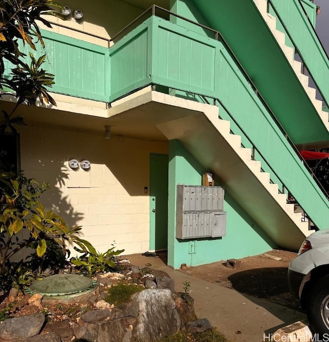 view of side of home with mail boxes