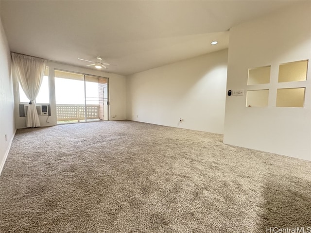 empty room with ceiling fan, cooling unit, and carpet floors