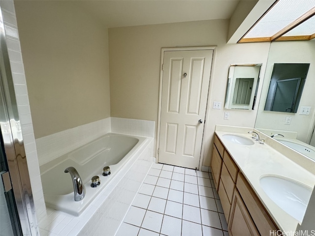 bathroom featuring tiled tub, tile patterned flooring, and vanity