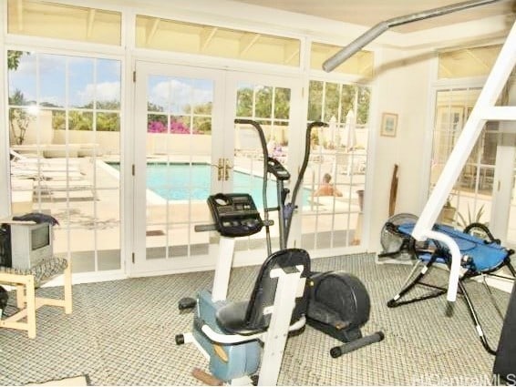 workout area with carpet flooring and french doors