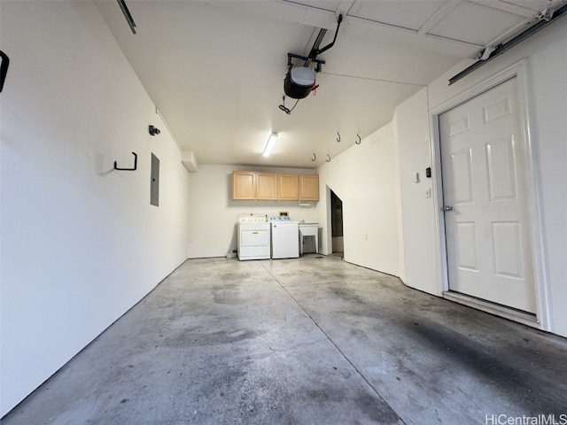 garage featuring electric panel, a garage door opener, and washing machine and clothes dryer